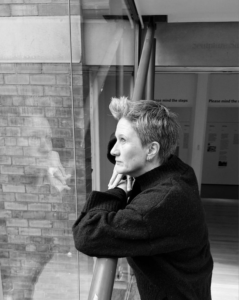 Black and white photo, side profile of Melika Clason founder of Therapeutic Consultancy looking wistfully into the distance